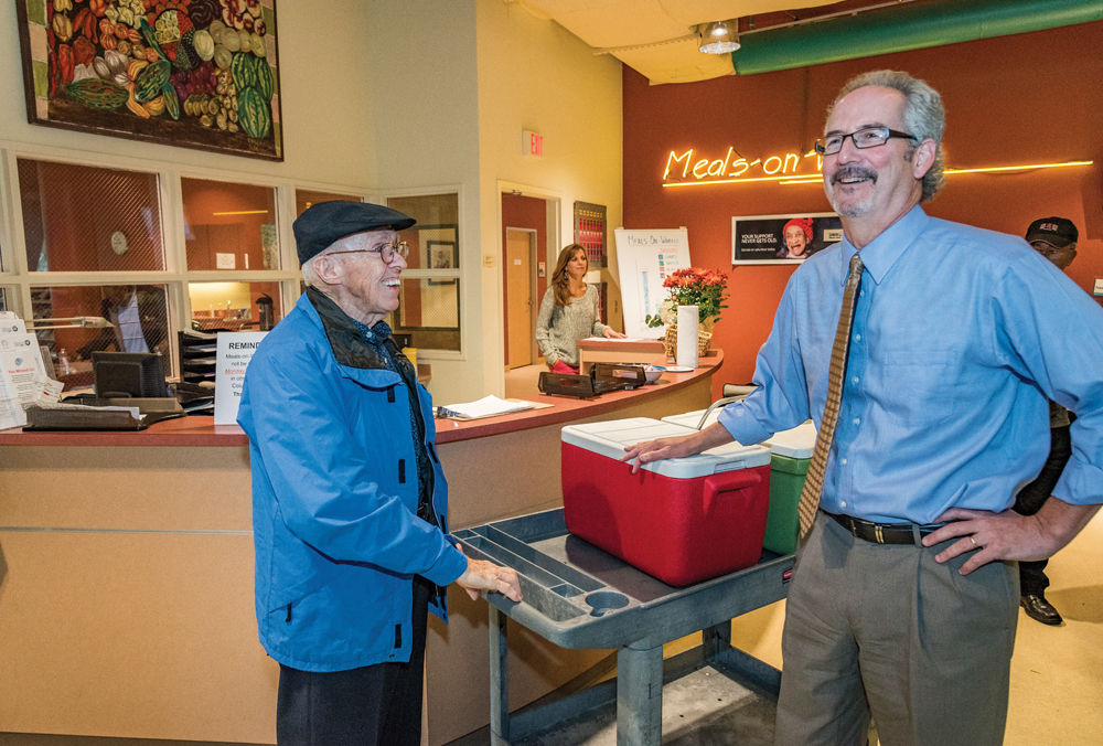 Senior Services’ President and CEO Richard Gottlieb (right) chats with volunteer Curtis Patterson.